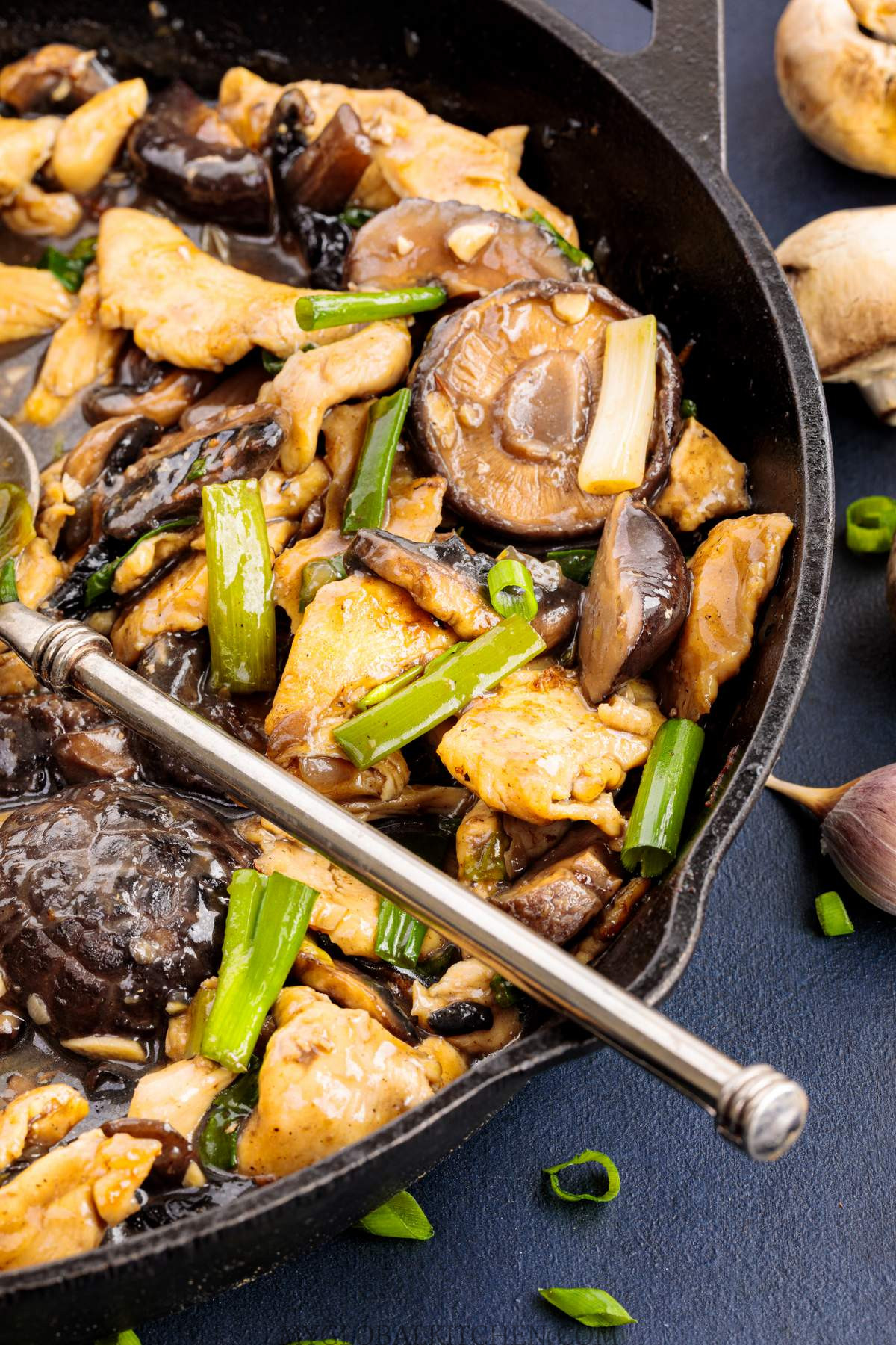Closeup view of Chinese chicken mushroom stir-fry in a skillet