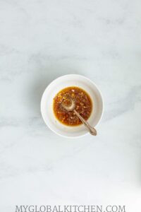 Rice vinegar dressing in a small white bowl
