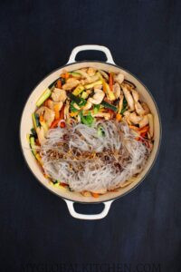Add the cooked noodles and sauce back to the stir-fry pot